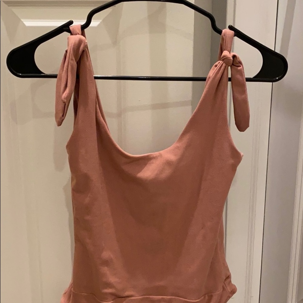 Dusty rose colored body suit.